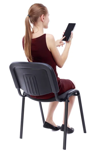 Back view of woman sitting on chair and looks at the screen — Stock Photo, Image