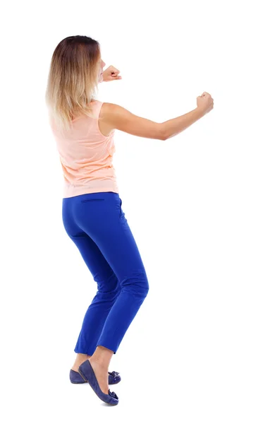 Back view of standing girl pulling a rope from top or cling to s — Stock Photo, Image