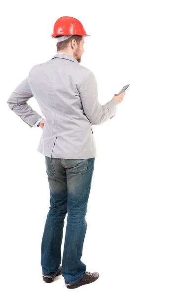 Backview of business man in construction helmet stands and enjoy — Stock Photo, Image