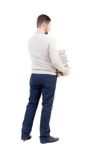 Man carries a heavy pile of books. — Stock Photo, Image