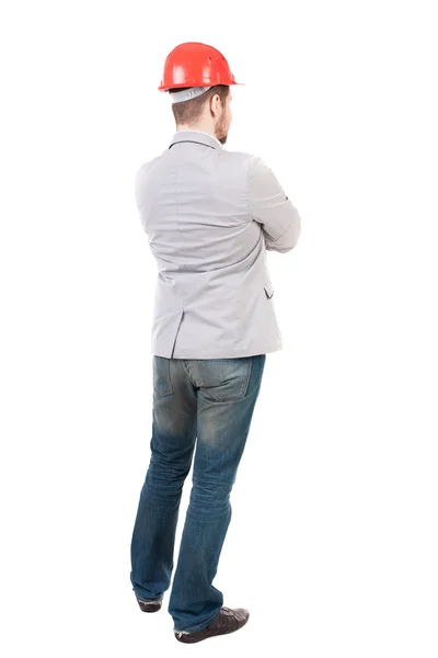 Backview of an engineer in construction helmet stands. — Stock Photo, Image