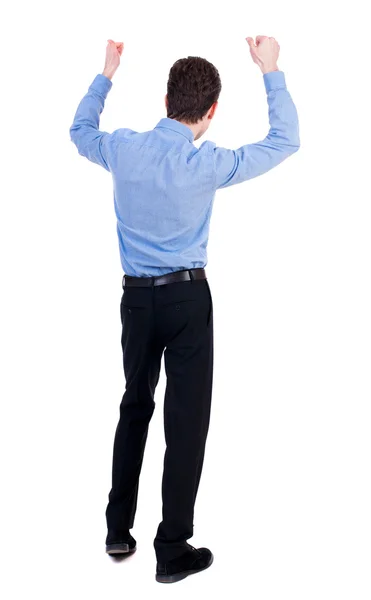 Back view of  man.  Raised his fist up in victory sign. Stock Photo