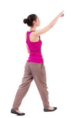 back view of pointing walking  woman