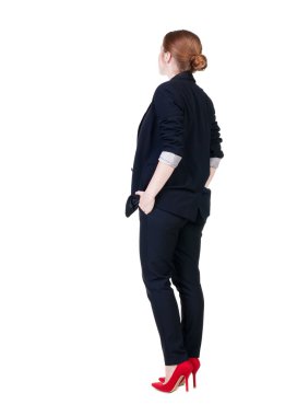 Arkadan redhead iş kadını düşünürken görünüşü.