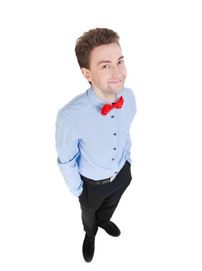 Smiling businessman in a bow tie looking up. top view.