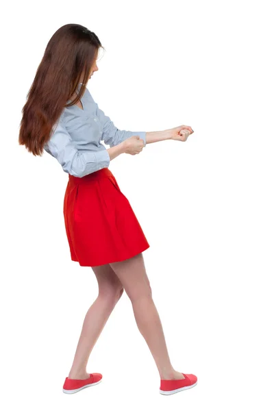 Back view of standing girl pulling a rope from the top or cling — Stock Photo, Image