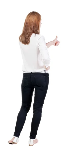 立っている赤毛の若いビジネス女性示す親指の背面図 — ストック写真