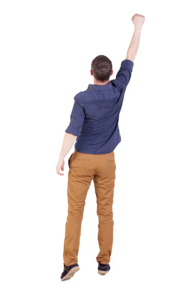 Back view of  man in checkered shirt Raised his fist up in victo — Stock Photo, Image