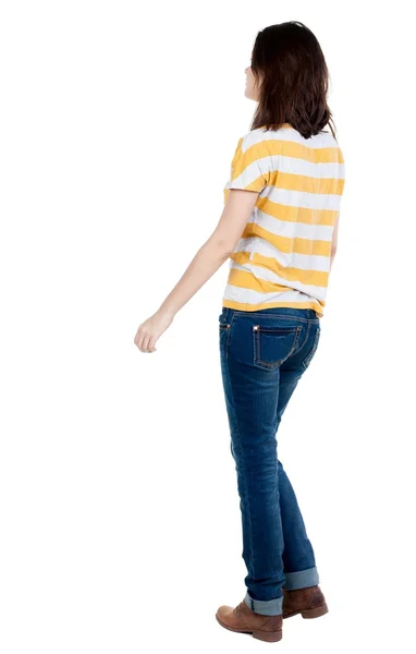 Back view of walking  woman in jeans . — Stockfoto