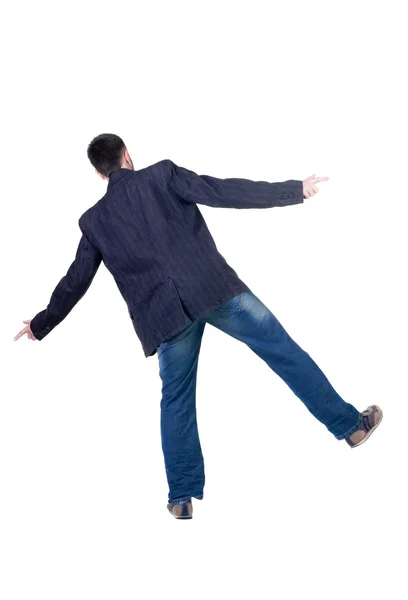 Balancing young man in jacket. Rear view. — Stock Photo, Image