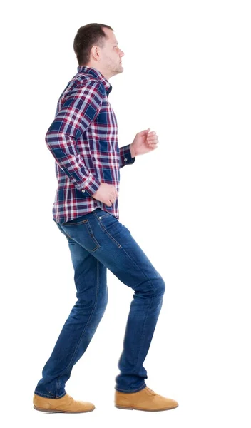 Back view of running man in checkered shirt. — Stock Photo, Image