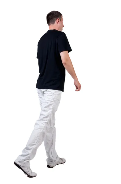 T シャツのハンサムな男を歩いての背面図 — ストック写真