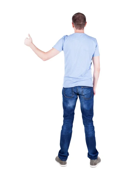 Zadní pohled na člověka v tričku. ukazuje palec. — Stock fotografie
