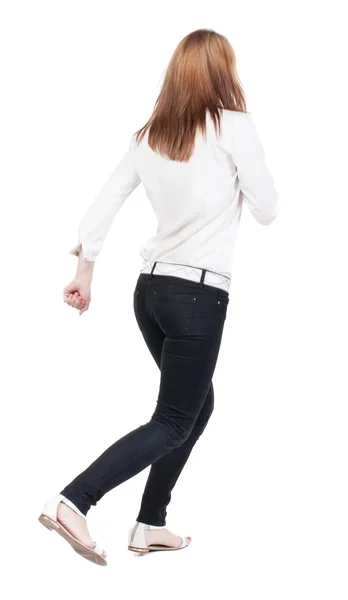 Back view of running  woman in jeans — Stock Photo, Image