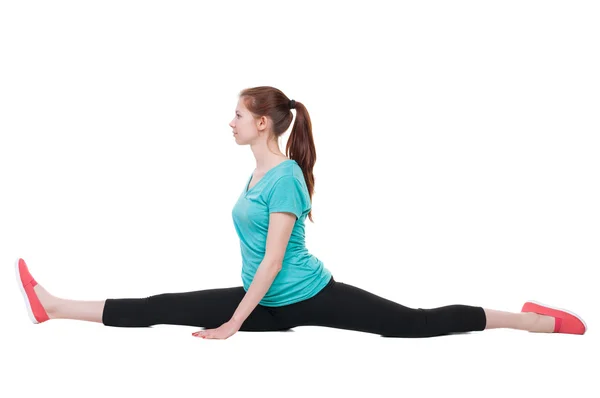 Side view of the girl in sportswear sitting on  splits. — Stock Photo, Image