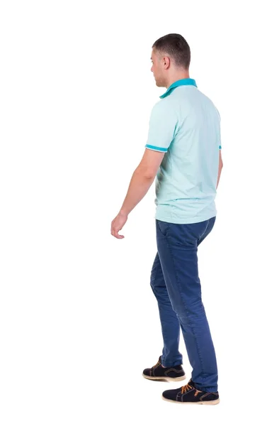 Back view of going  handsome man in jeans and a shirt. — Stock Photo, Image