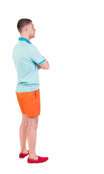 Rückansicht des jungen Manin Shorts suchen. — Stockfoto