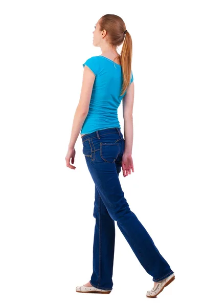 Back view of walking  woman  in   jeans and shirt. — Stock Photo, Image