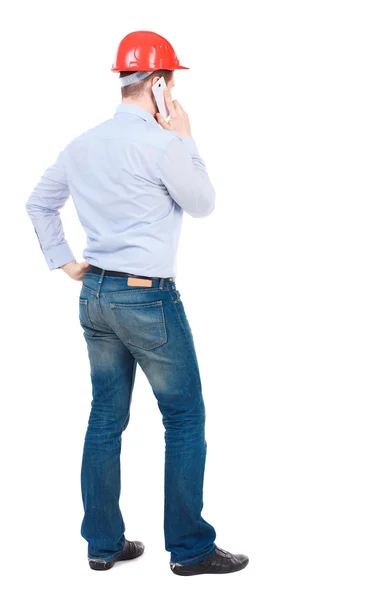 Backview of business man in construction helmet stands and enjoy — Stock Photo, Image