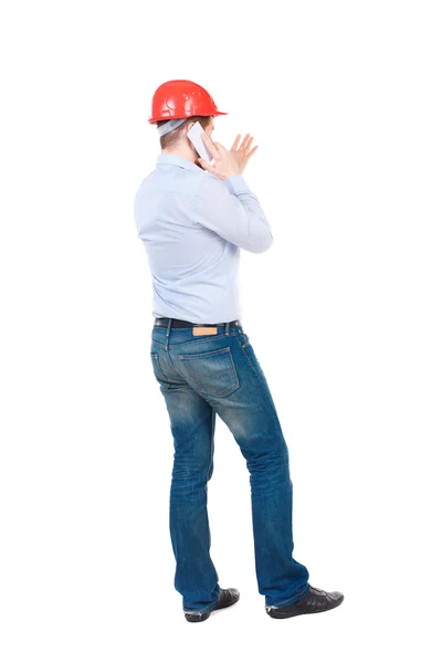 Backview of business man in construction helmet stands and enjoy — Stock Photo, Image