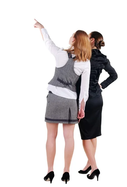 Two beautiful young bussineswoman looking at wall. Rear view. Is — Stok fotoğraf