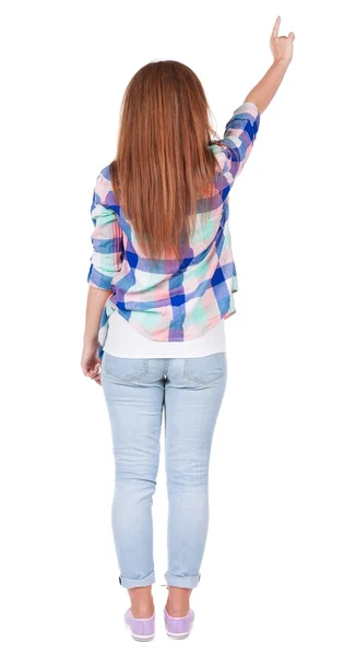 背面ポインティング女性の図。ジーンズで美しい赤毛の女の子. — ストック写真