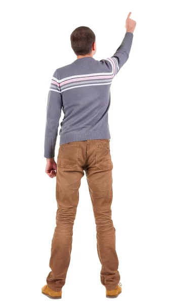 Back view of  pointing young men in  sweater and jeans — Stock Photo, Image
