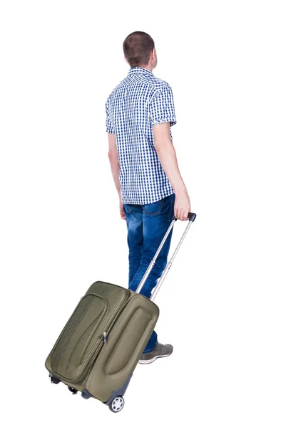 Bakifrån av man med grön resväska tittar upp. — Stockfoto