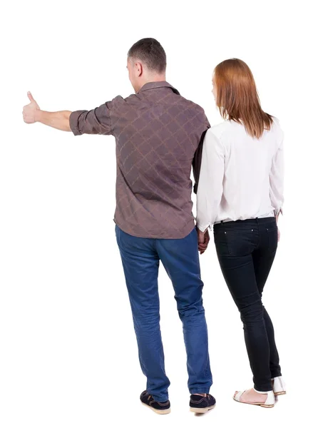 Jovem casal apontando wal vista traseira — Fotografia de Stock