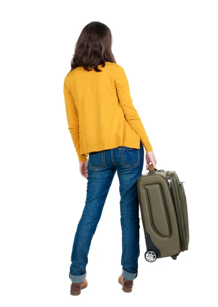 Powrót widok kobieta z walizką. — Zdjęcie stockowe
