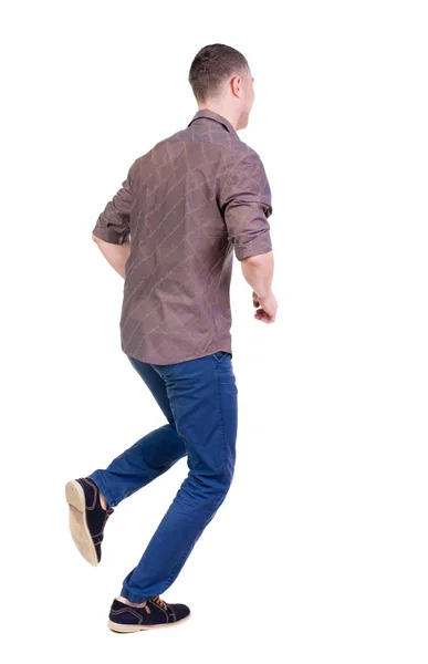 Back view of running man in brown shirt. — Stock Photo, Image