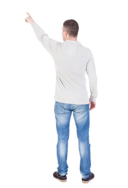 Back view of  pointing young men in  shirt and jeans. — Stock Photo, Image
