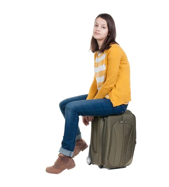 Side view of walking  woman  in cardigan sits on a suitcase. — Stock Photo, Image