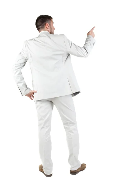 Businessman pointing at wall. rear view. — Stock Photo, Image