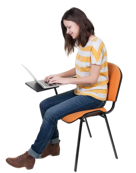 Side view of  woman sitting on a chair to study with  laptop. — Foto de Stock
