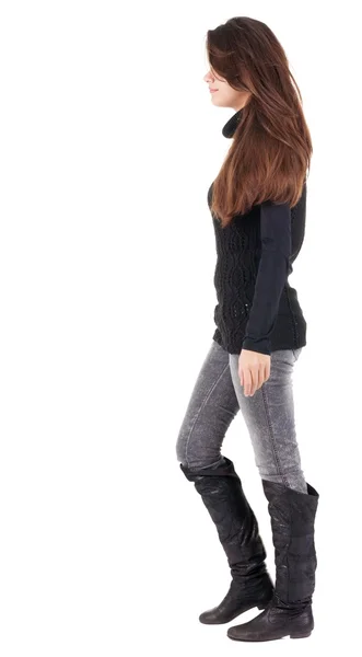 Back view of going  woman  in jeans and sweater — Stock Photo, Image