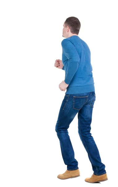 Rückansicht der Ausführung Mann im blauen pullover. — Stockfoto