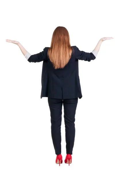 Rückansicht des schönen geschäftsfrau in Suite, Blick auf Mauer und hält die Hand hoch. — Stockfoto