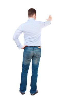 back view of man presses down on something.