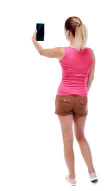 arkadan görünüşü bir mobil pho kullanan duran genç güzel kadın