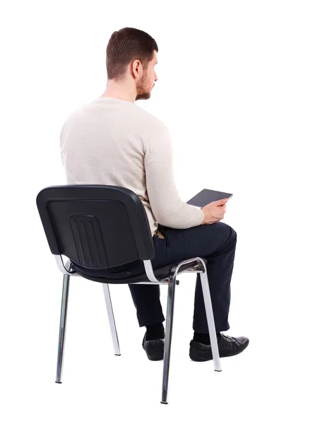 Back view of man sitting on chair and looks at the screen — Stock Photo, Image