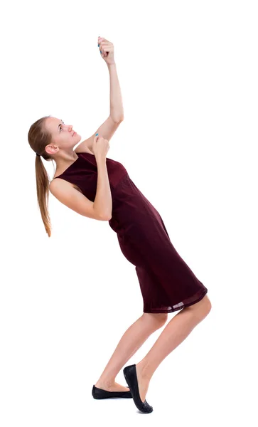 Widok dziewczyny stojącej ciągnięcie liny z góry z tyłu lub czepiać — Zdjęcie stockowe