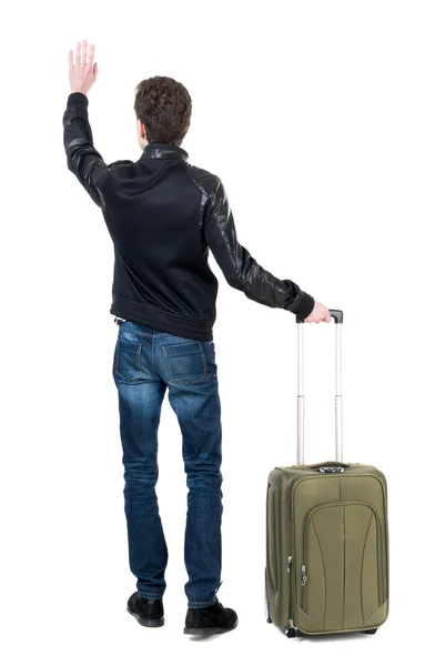 Back view of man with a bag greeting waving from his hands — Stock Photo, Image