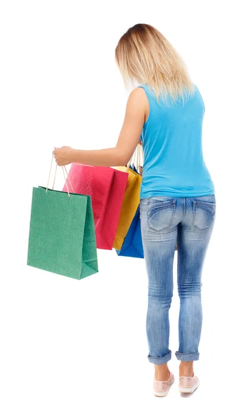 Visão traseira da mulher com sacos de compras — Fotografia de Stock