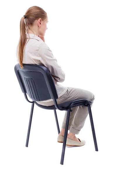 Back view of young beautiful  woman sitting on chair. — Stock Photo, Image