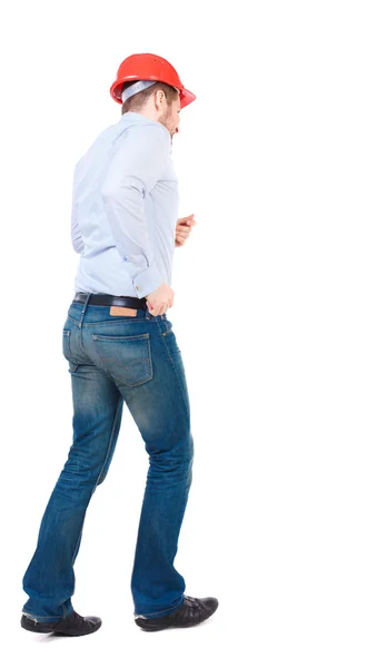 Back view of running engineer in helmet. — Stock Photo, Image