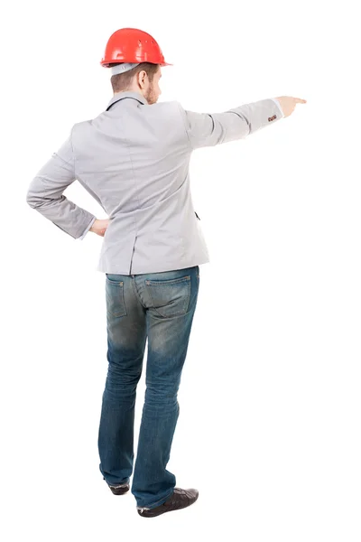 Back view of  pointing young men in helmet. — Stock Photo, Image