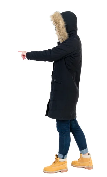 Back view of  pointing young women in parka. — Stock Photo, Image