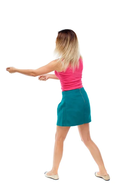 Back view of standing girl pulling a rope from the top or cling — Stock Photo, Image