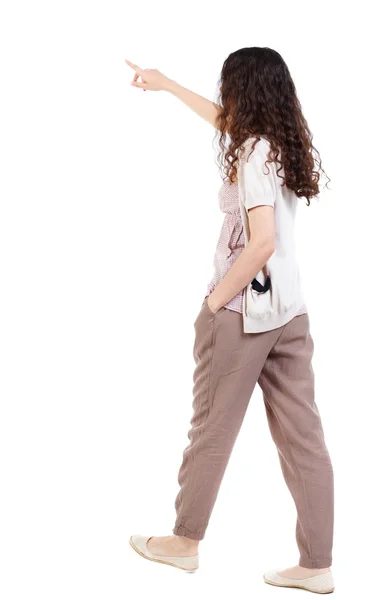 Back view of pointing walking  woman — Stock Photo, Image